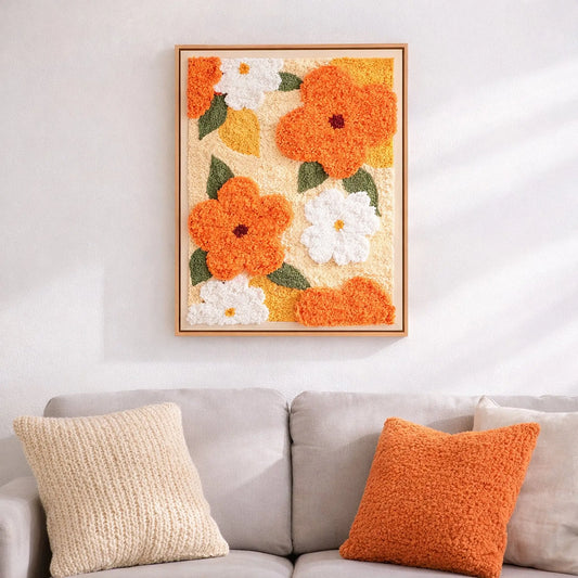 Punch needle embroidery artwork displayed on wall above sofa, cozy home decor with floral handmade texture