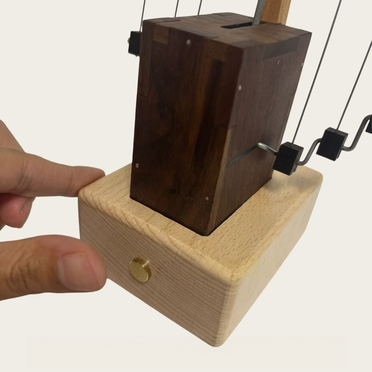 Close-up of the wooden mechanical base and suspension system of the dragon automaton.