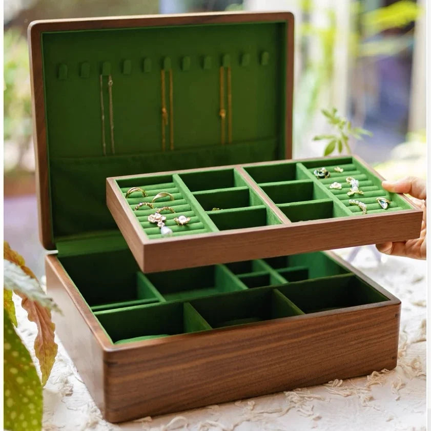 Open black walnut jewelry box with a removable tray revealing two storage levels