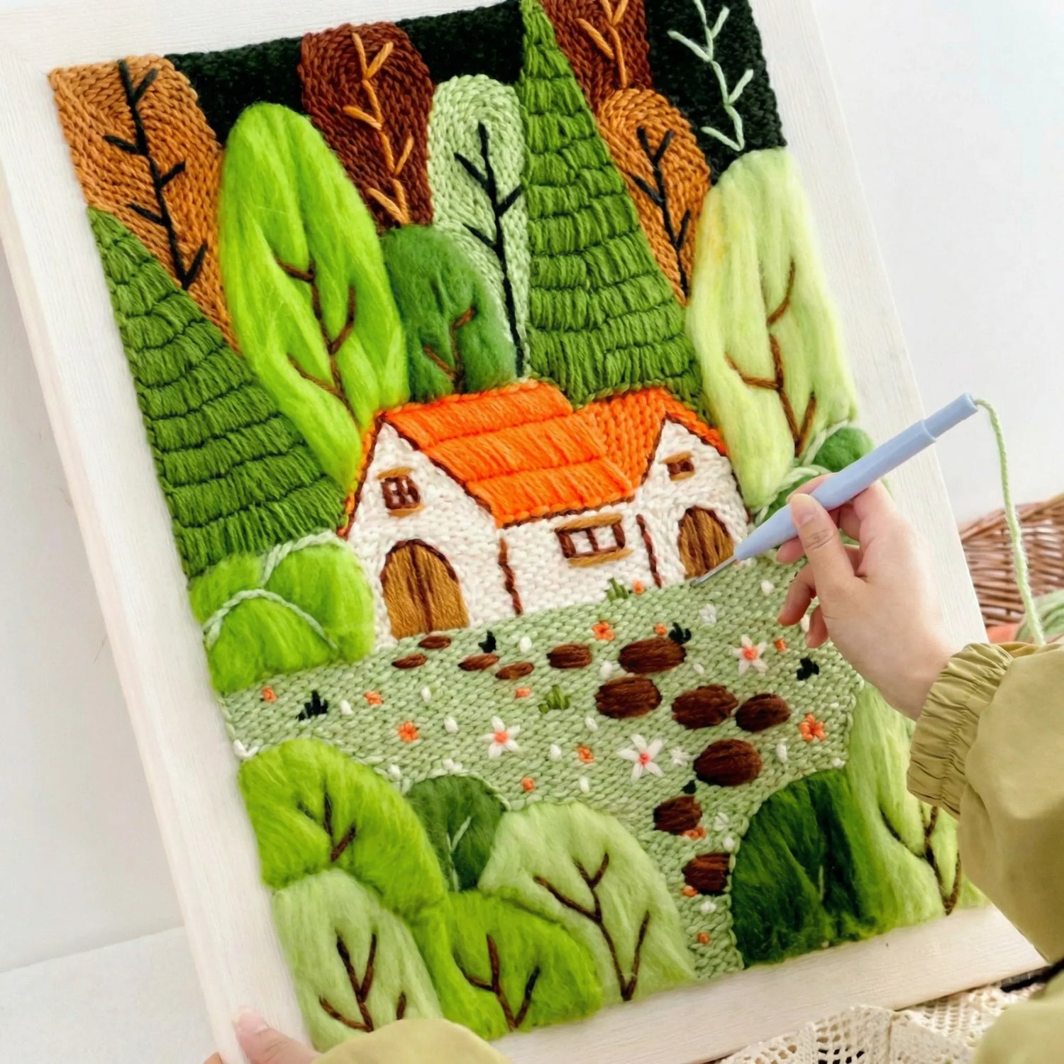 punch needle embroidery process for forest cottage wall art