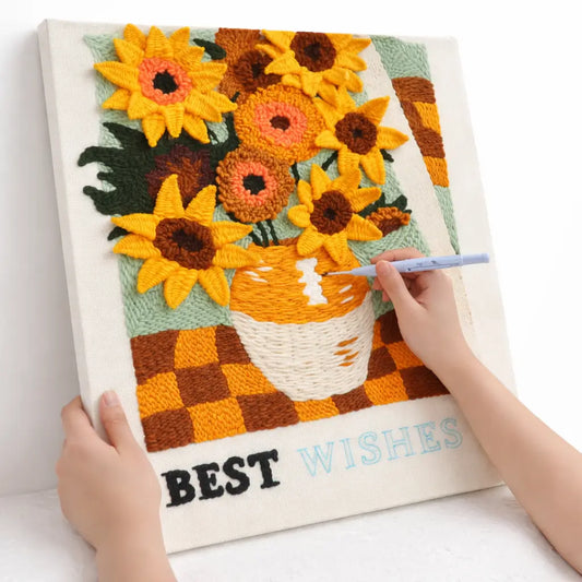 Beginner working on sunflower punch needle embroidery kit with punch needle tool and pre printed fabric