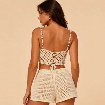 Back view of model wearing cream pearl strap crochet top and matching crochet shorts