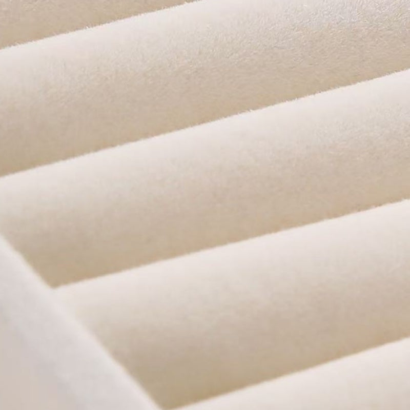 Close-up of soft cream velvet lining inside the jewelry box
