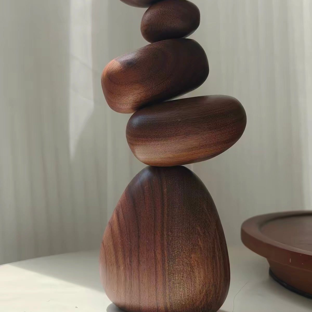 Close-up of Black Walnut magnetic wooden balance stones showing natural grain and balanced organic shapes