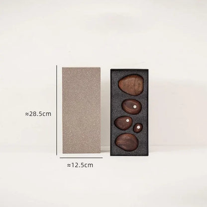 Black Walnut magnetic wooden balance stones arranged inside a fitted gift box with an outer sleeve