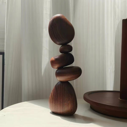 Black Walnut magnetic wooden balance stones arranged on a tabletop beside a wooden tray