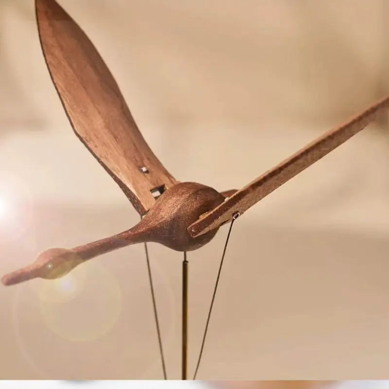 Close-up of the walnut swan wings and mechanical linkage