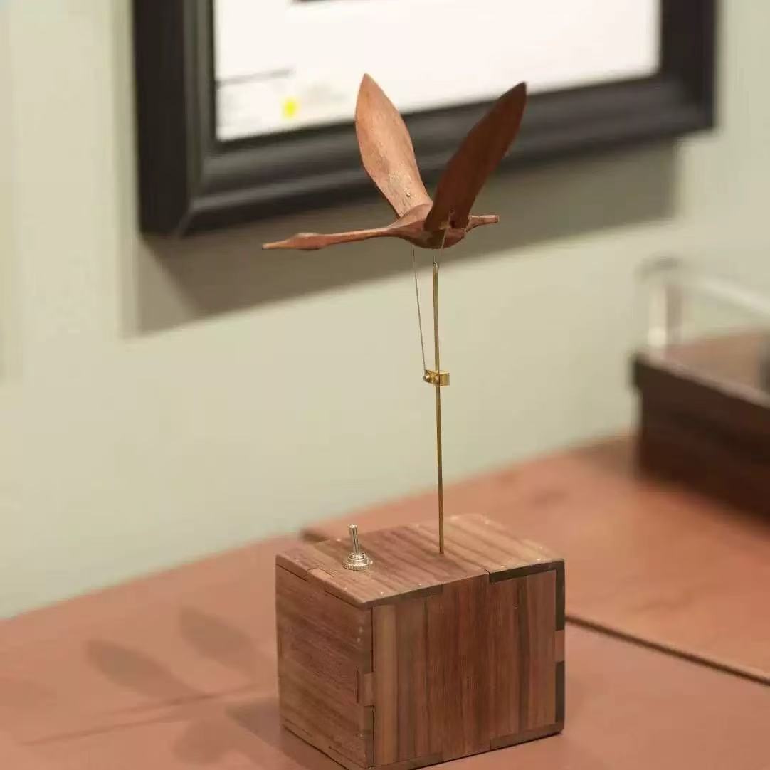 Wooden swan kinetic desk sculpture with toggle switch