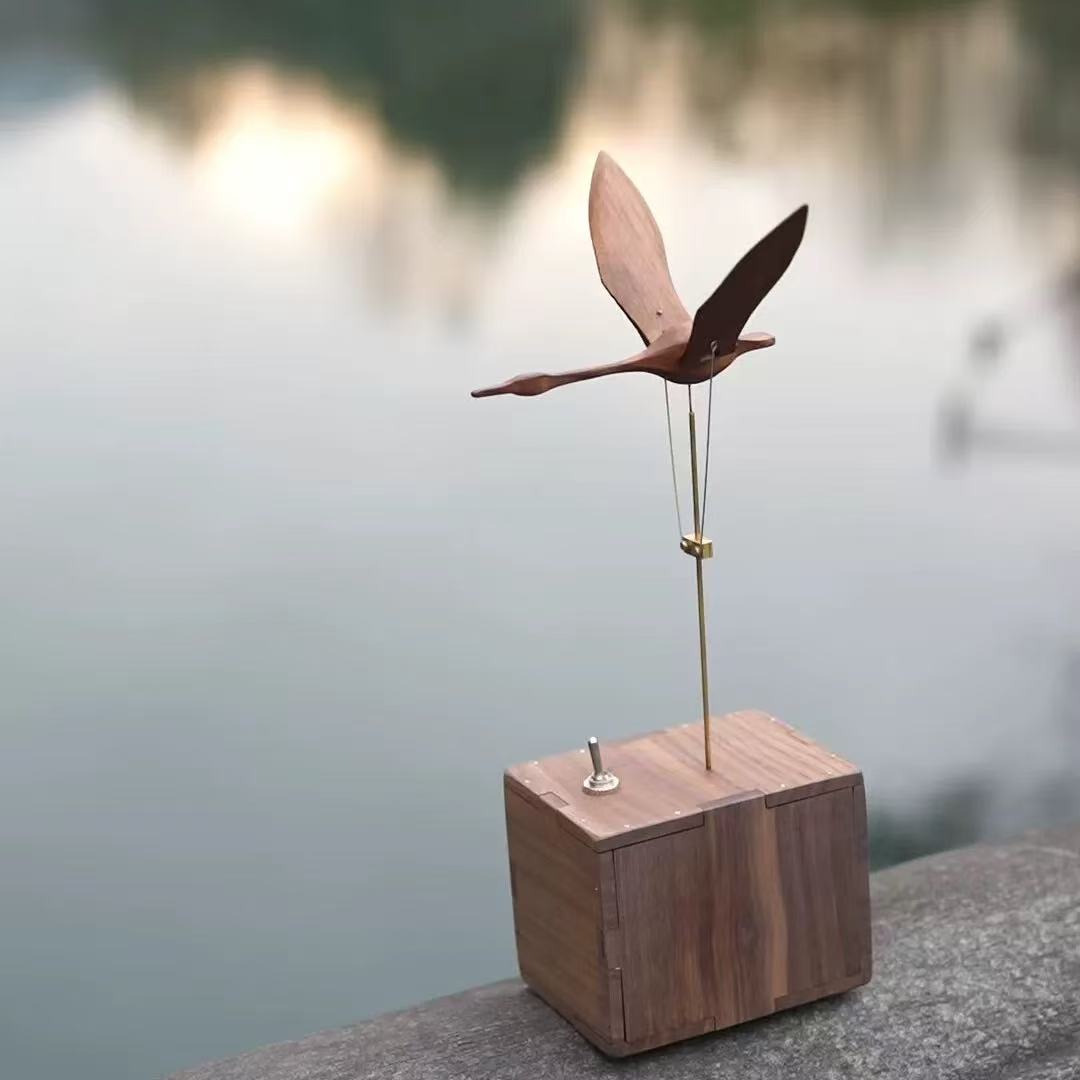Walnut swan sculpture with natural wood grain on the base