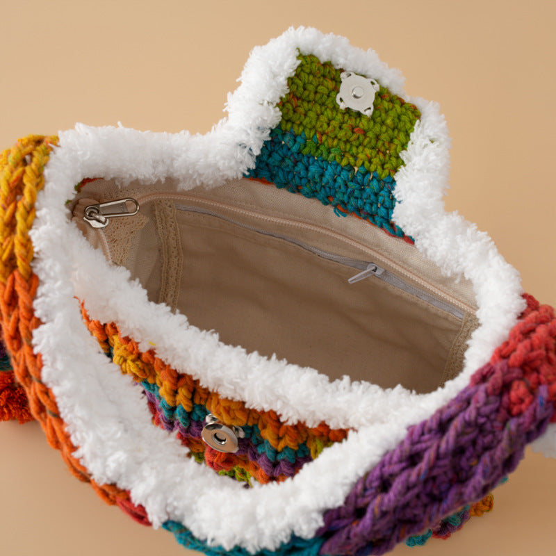 Open colorful crochet handbag with soft white trim, fabric lining and zip pocket detail.