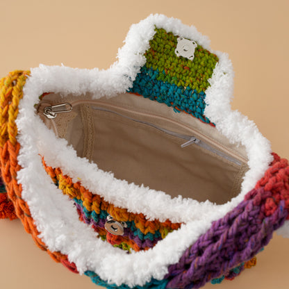 Open colorful crochet handbag with soft white trim, fabric lining and zip pocket detail.
