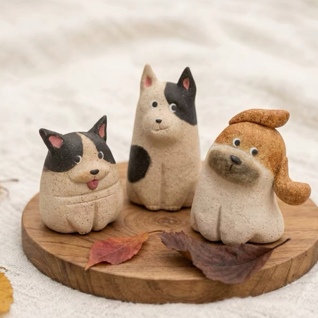 Set of three dog-shaped aroma stone diffusers in different designs displayed on a wooden tray