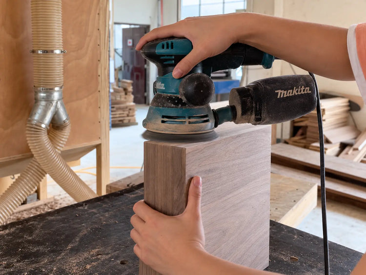 AI-edited illustration based on supplier footage: sanding the surface of a wooden box