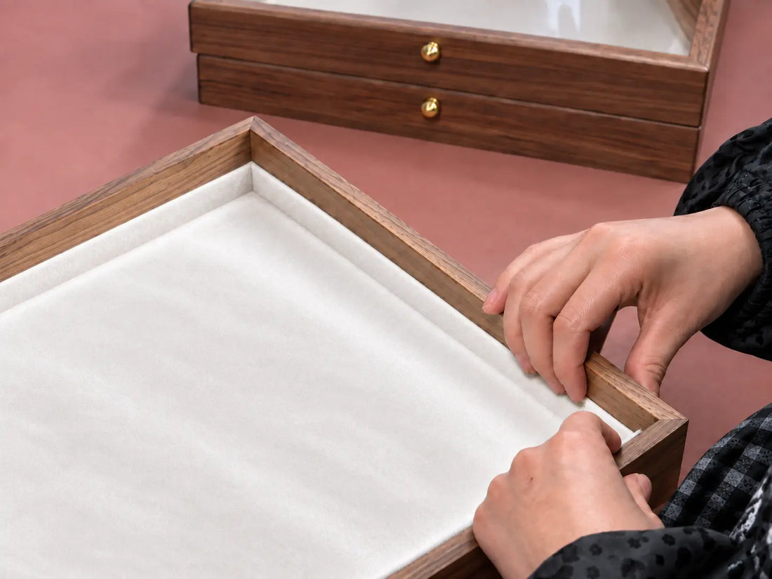 AI-edited illustration of a jewelry-box lining being fitted by hand