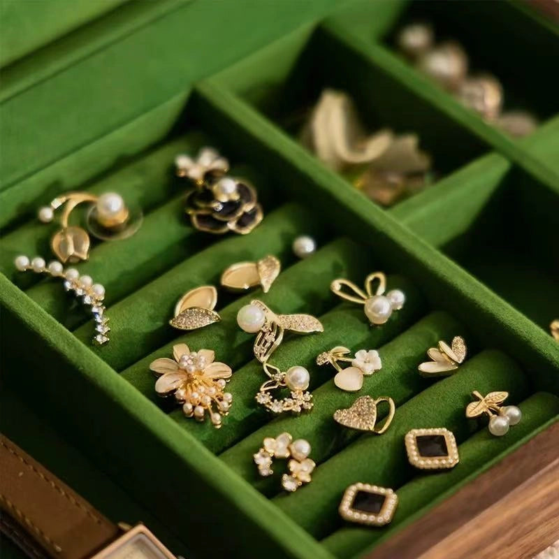 Close-up of green velvet ring rolls and divided compartments in the Fern jewelry box