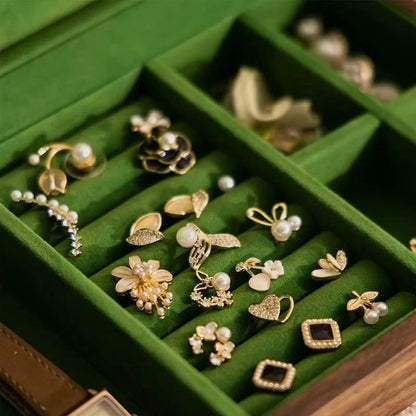 Close-up of green velvet ring rolls and divided compartments in the Fern jewelry box