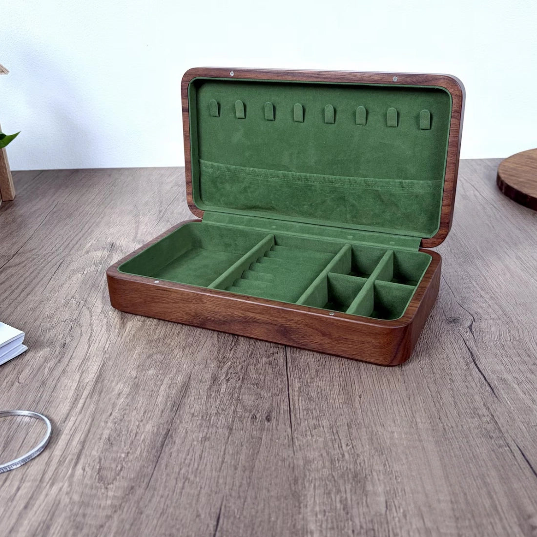 Large Fern walnut jewelry box open with empty green velvet compartments, ring rolls and necklace storage