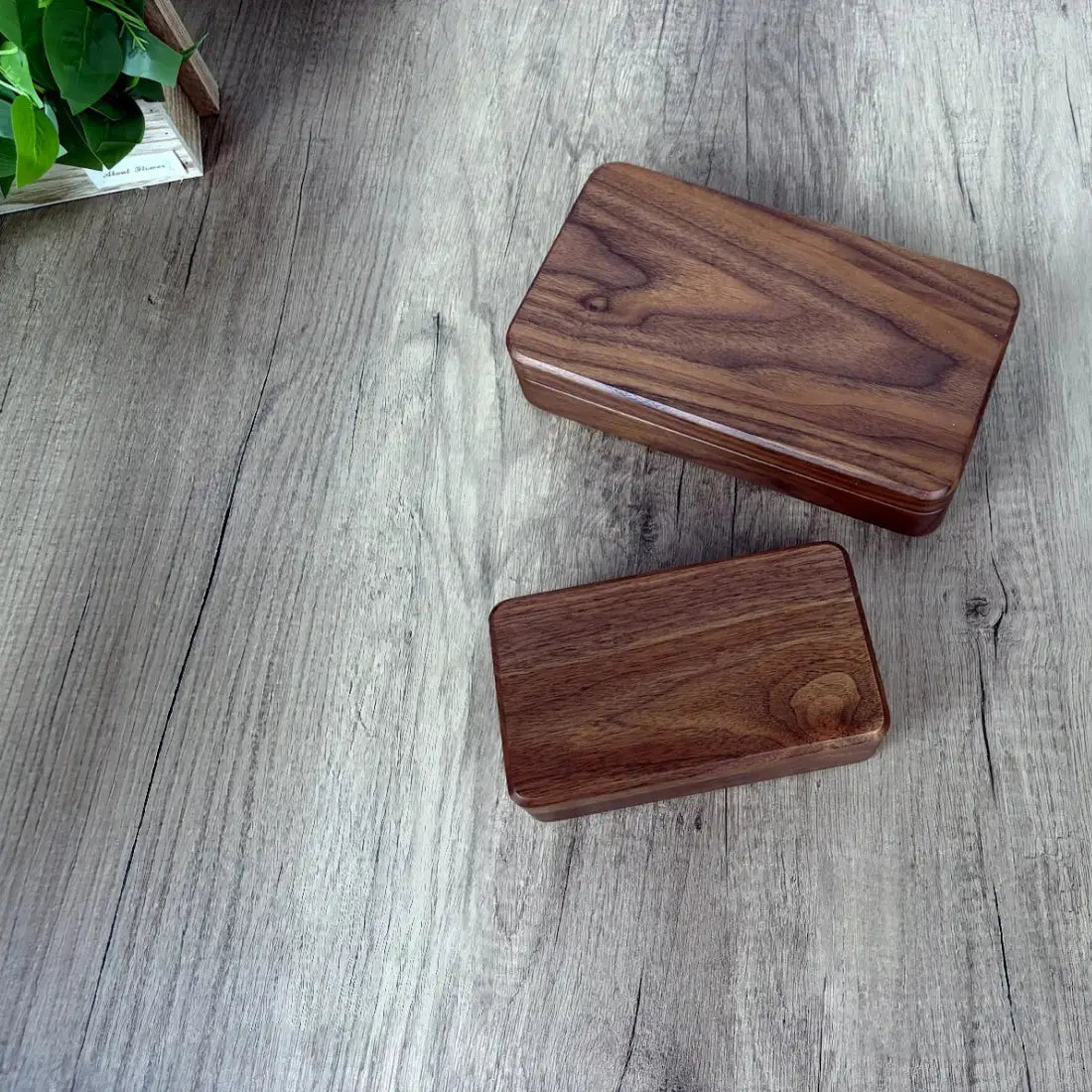 Small and large Fern walnut jewelry boxes with closed lids showing their natural wood grain
