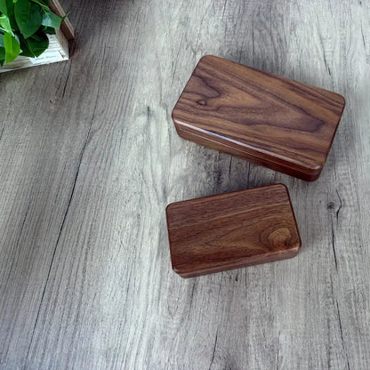 Small and large Fern walnut jewelry boxes with closed lids showing their natural wood grain