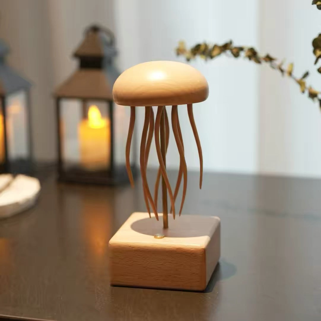 Hand-carved wooden jellyfish automaton kinetic sculpture on a wave-inspired base