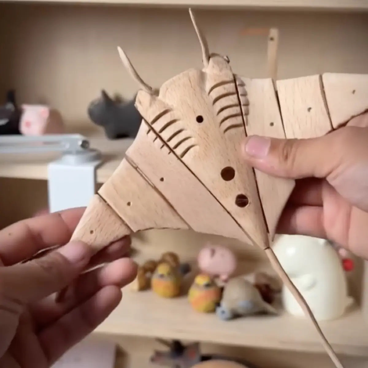Handcrafted wooden manta ray kinetic sculpture with articulated solid wood wings.