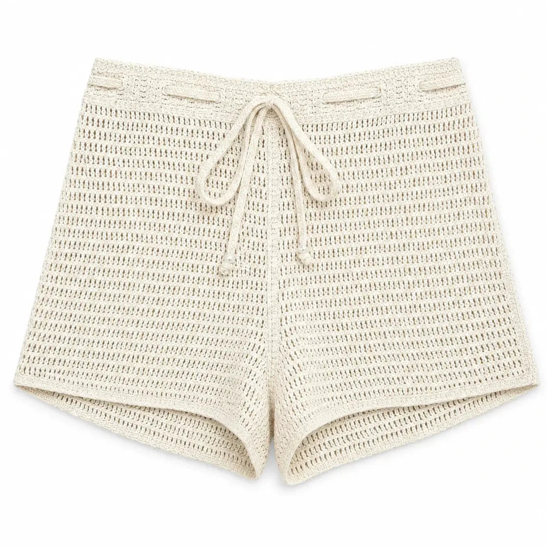 Cream crochet shorts with an openwork knit texture, elastic waistband, and adjustable drawstring on a white background