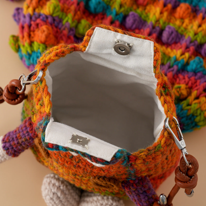 Interior detail of a handmade crochet bag showing the fabric lining, snap closure and spacious compartment