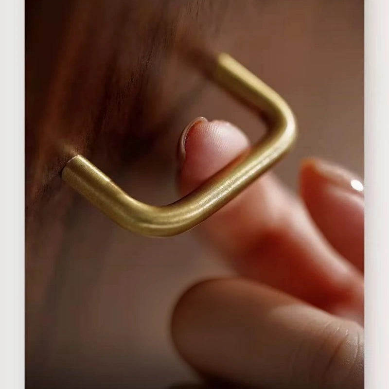 Close-up of the brushed brass door handle on the Haven solid walnut jewelry box