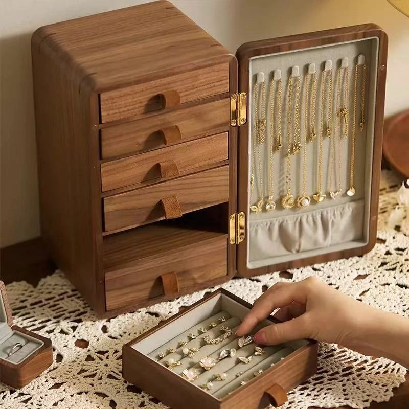 Haven walnut jewelry organizer with open drawers and necklaces arranged inside the door