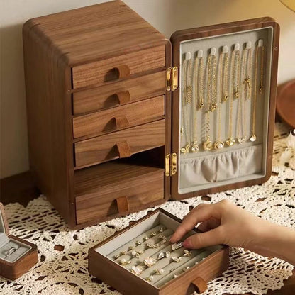 Haven walnut jewelry organizer with open drawers and necklaces arranged inside the door