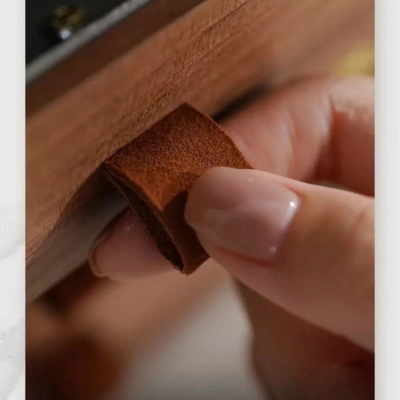 Close-up of the genuine cowhide suede drawer pull on the Haven walnut jewelry box