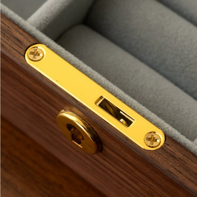 Close-up of the vintage-style gold-tone latch on the black walnut jewelry box
