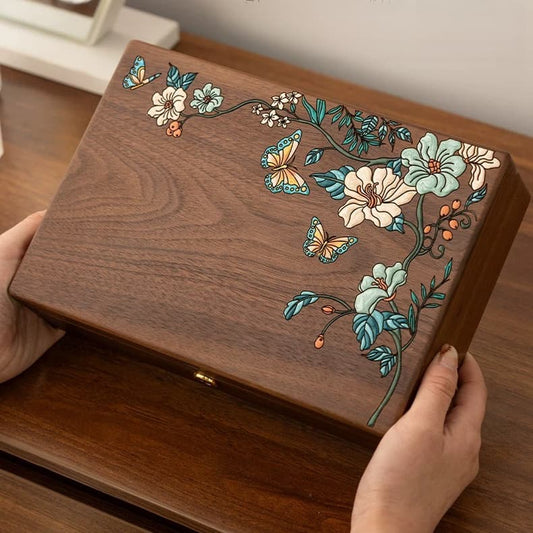Hand-held black walnut jewelry box featuring colorful hand-painted flowers and butterflies