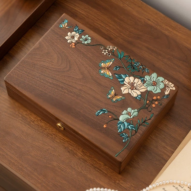 Top view of Huadie walnut jewelry box with raised floral and butterfly artwork