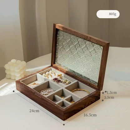 Open black walnut Maren jewelry box with floral-patterned glass lid, light velvet lining and jewelry compartments.