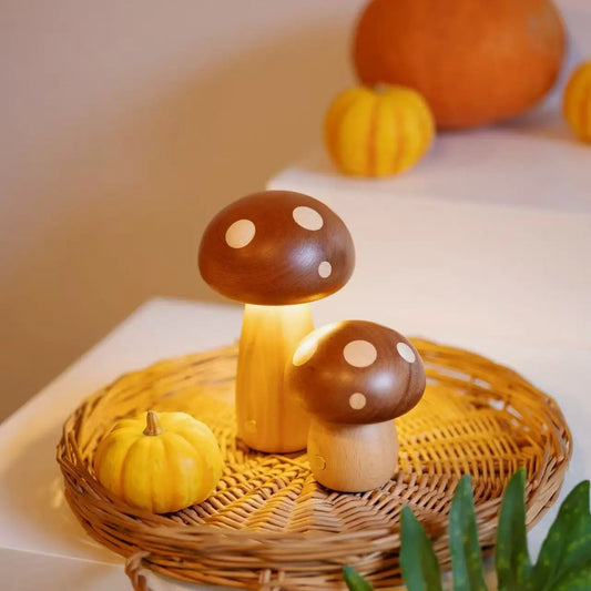Wooden mushroom lamp pair on a wicker tray with autumn pumpkins