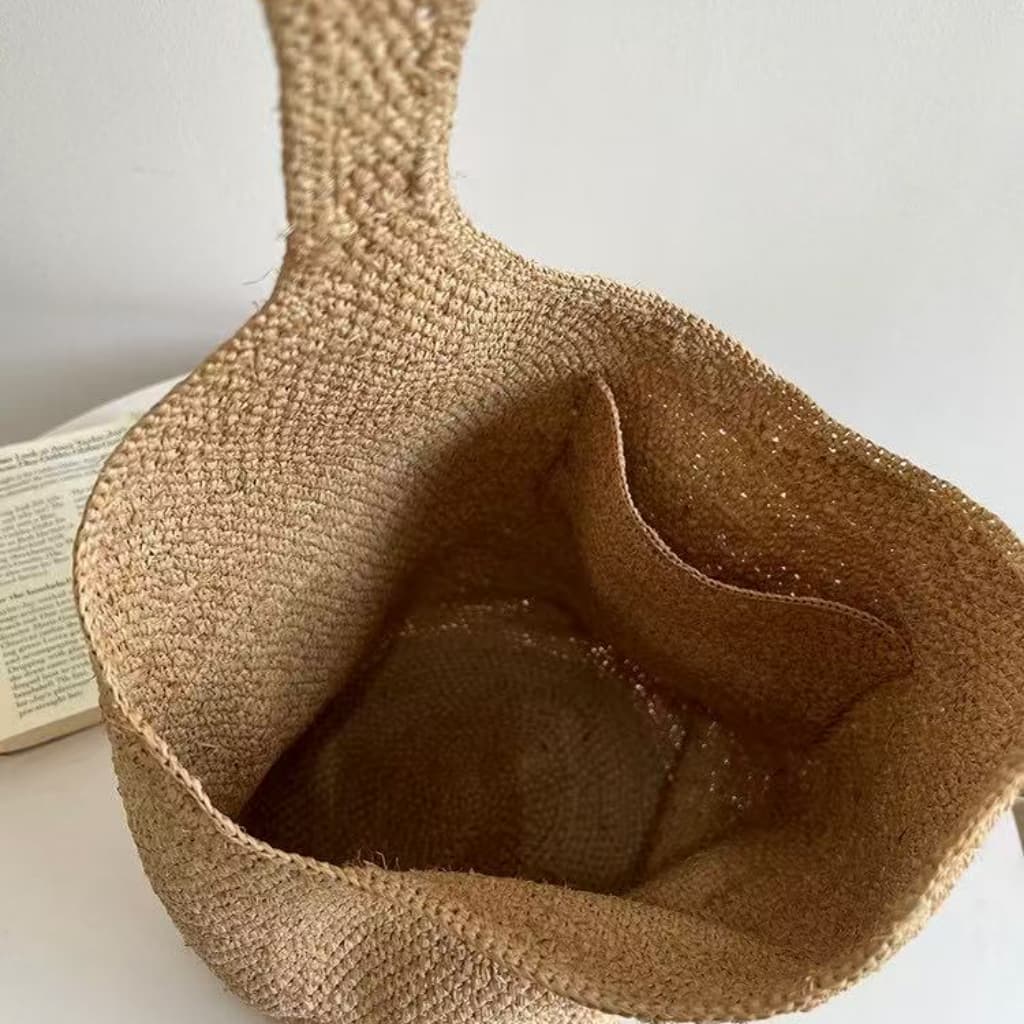 Natural handwoven raffia bucket tote bag interior with storage pocket