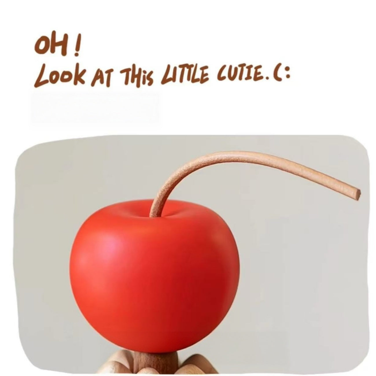 Close-up of the red cherry topper on the solid wood Christmas tree trivet stand.