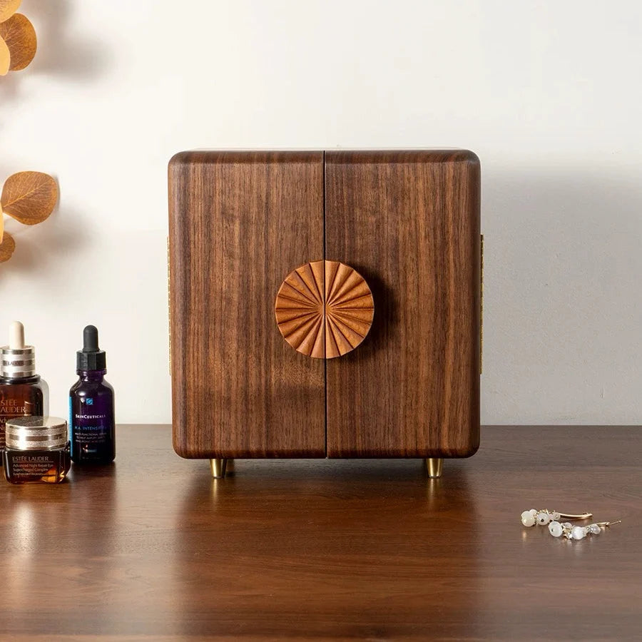 Front view of the closed Solaris walnut jewelry box with rounded corners and raised feet