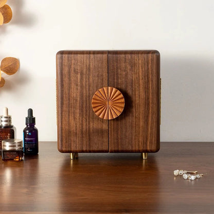 Front view of the closed Solaris walnut jewelry box with rounded corners and raised feet