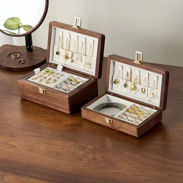 Single-layer and double-layer walnut jewelry boxes with ivory velvet interiors displayed side by side.