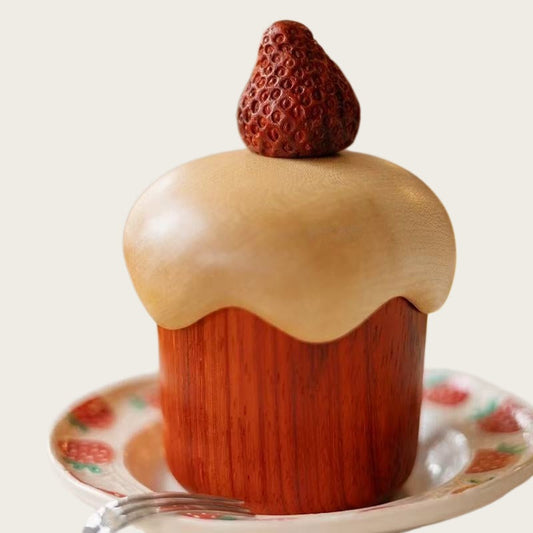 Rosewood and maple strawberry cake storage box with a sculpted frosting lid and strawberry topper