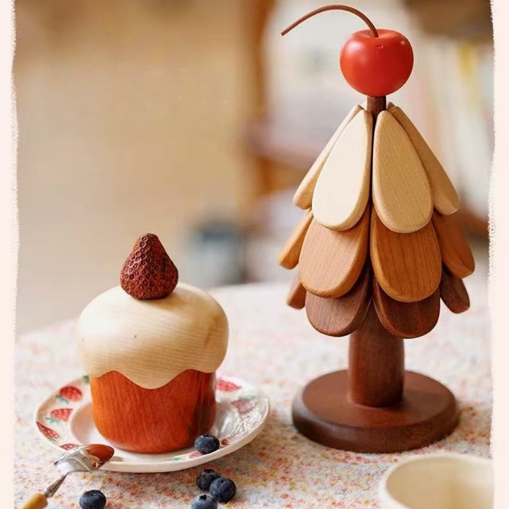 Rosewood and maple strawberry cake storage box beside a decorative wooden tree