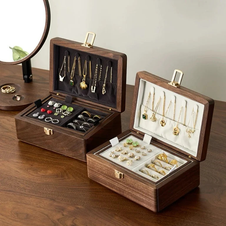 Two double-layer walnut jewelry boxes with dark gray and ivory velvet interiors and removable upper trays.