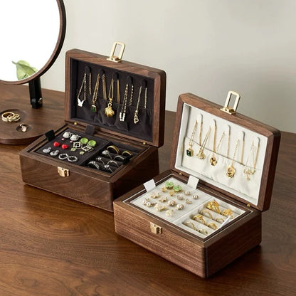 Two double-layer walnut jewelry boxes with dark gray and ivory velvet interiors and removable upper trays.