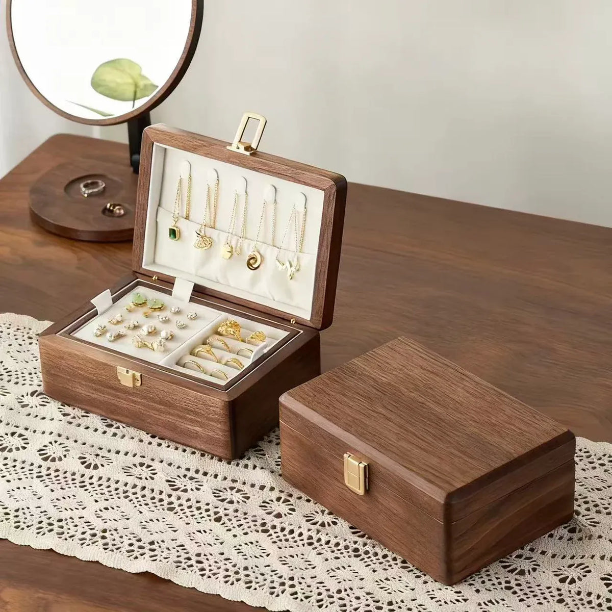 Double-layer walnut jewelry boxes displayed open and closed, showing ivory lining and natural wood grain.