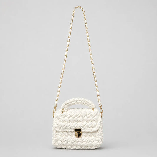 White chunky crochet top handle bag shown on a clean background with gold hardware and a detachable woven shoulder strap