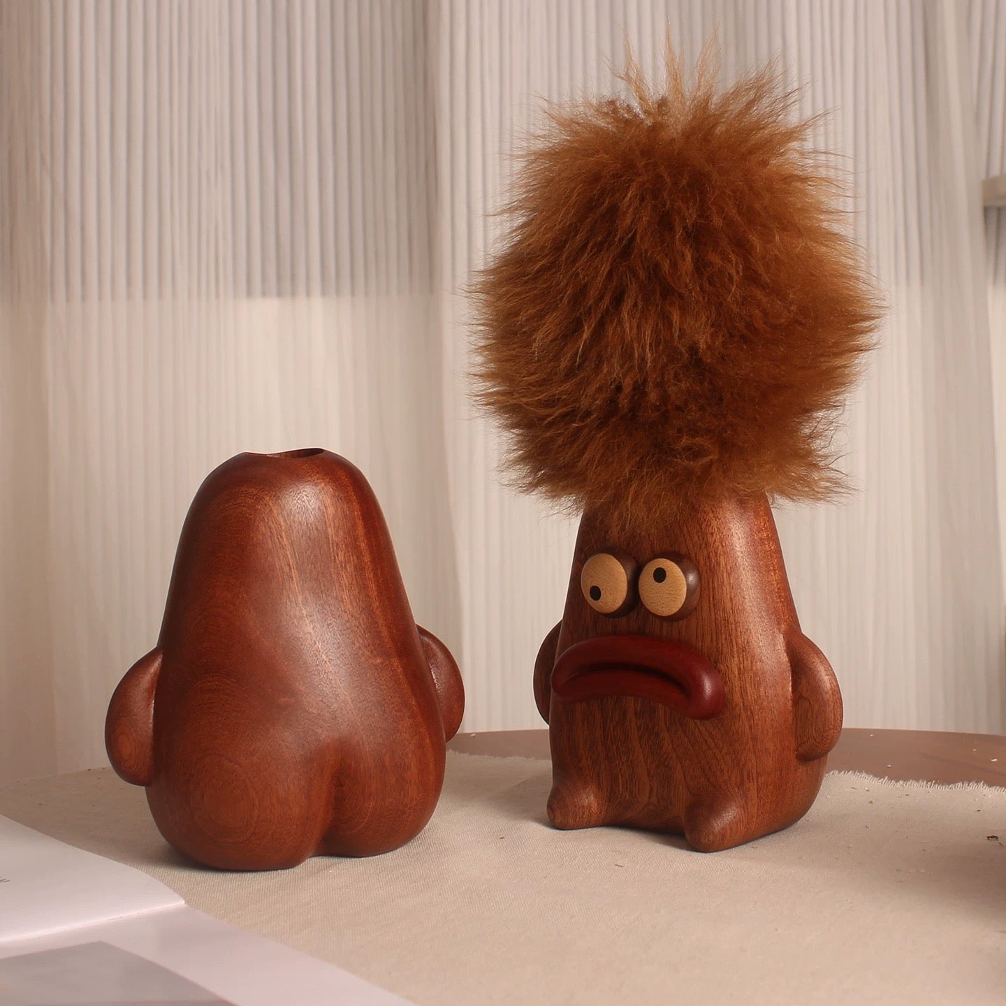 Front and back views of the wooden character holder, shown empty and with the lambswool duster stored inside.