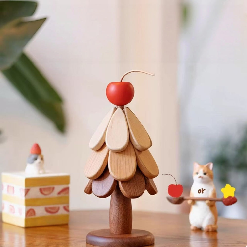 Wooden Christmas tree trivet set assembled as tabletop decor with a red cherry topper.