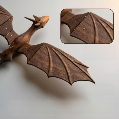 Close-up of the hand-carved body and textured wings of a solid wood dragon automaton.